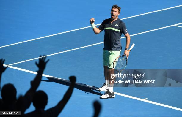 Switzerland's Stanislas Wawrinka reacts after a point against Lithuania's Ricardas Berankis during their men's singles first round match on day two...