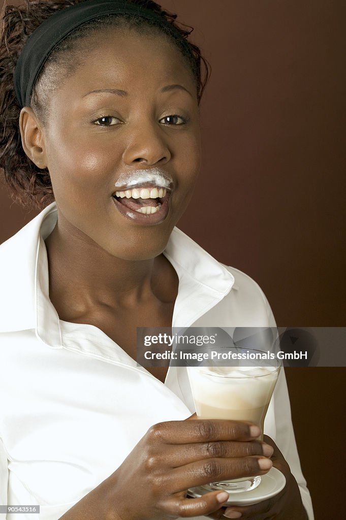 Woman drinking latte macchiato, close up