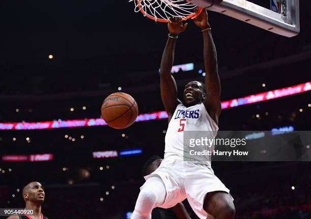 Montrezl Harrell of the LA Clippers reacts as he dunks the ball in front of Chris Paul of the Houston Rockets during a 113-102 Clipper win at Staples...