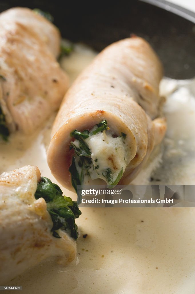 Veal rolls with spinach stuffing in cream sauce, close up