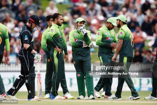 Sarfraz Ahmed of Pakistan watch the big screen with the team as they wait for an umpire decision during game four of the One Day International Series...