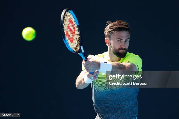Tim Smyczek of the United States plays a backhand in his first round match against Alexei Popyrin of Australia on day two of the 2018 Australian Open...