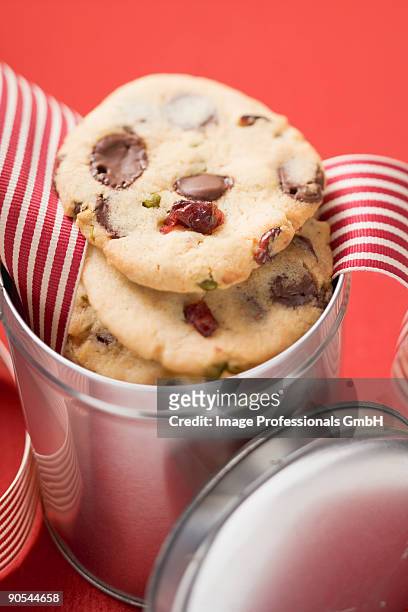chocolate chip cookies with cranberries in biscuit tin, close up - canned cranberry stock pictures, royalty-free photos & images