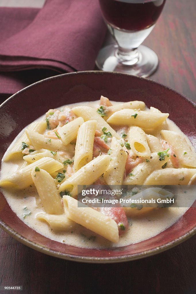 Penne with salmon and cream sauce, close up