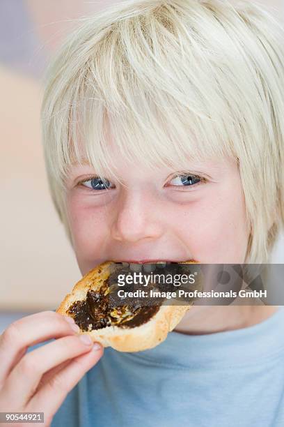boy eating vegemite on toast, close up - marmite stock pictures, royalty-free photos & images