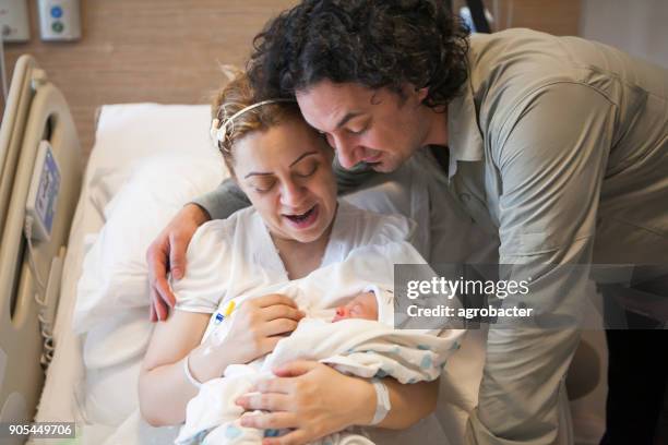 family with new born baby in post natal hospital department - maternity ward stock pictures, royalty-free photos & images