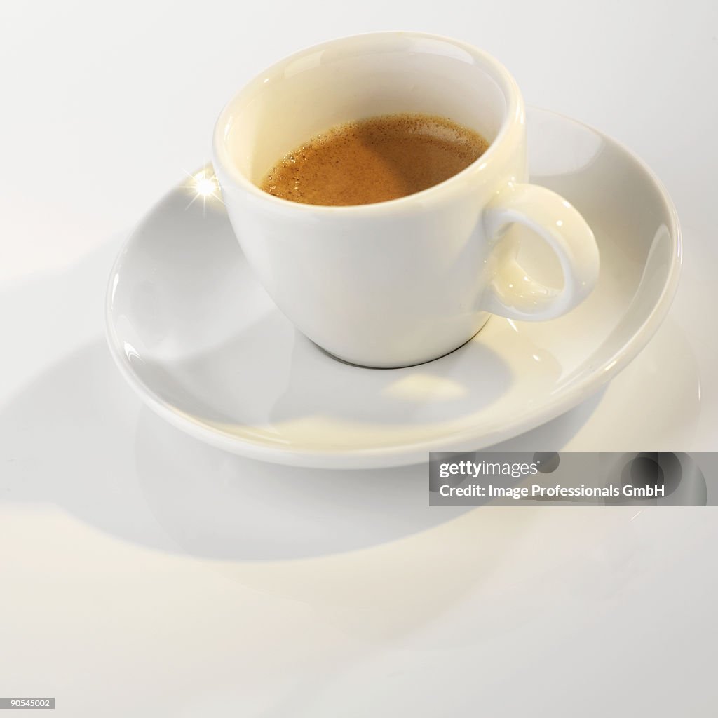 Cup of espresso on white background, close up