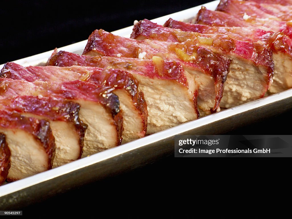 Chinese marinated pork on black background, close up