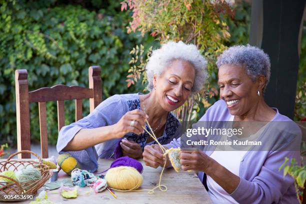 black women knitting outdoors - knitting stock pictures, royalty-free photos & images