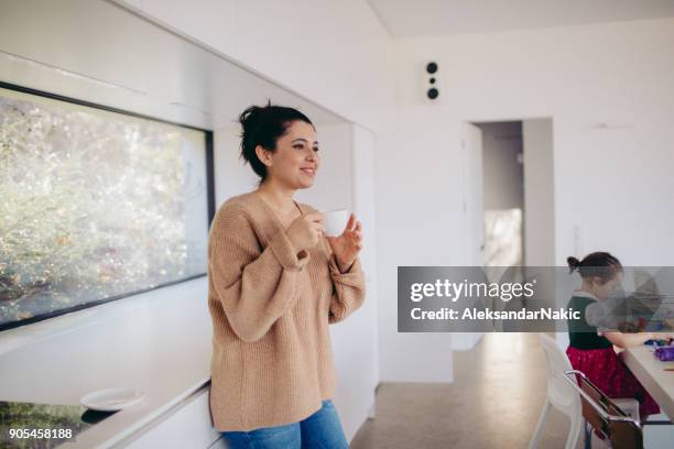 mom's morning coffee - messy hair bun stock pictures, royalty-free photos & images