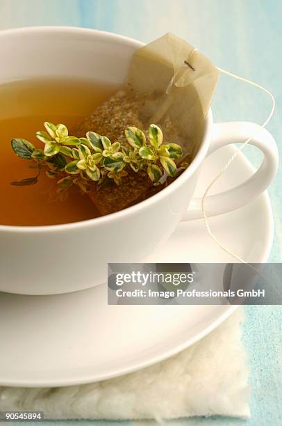 tea bag in tea cup, close up - herbal tea bag stock pictures, royalty-free photos & images