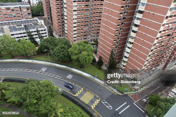 Car drives along a circular road, next to a residential block in Queenstown estate in Singapore, on Monday, Jan 15, 2018. Singapore sustained a...
