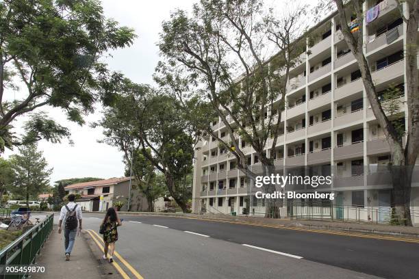 Pedestrians walk past the first public housing flats built in Singapore in Queenstown estate in Singapore, on Monday, Jan 15, 2018. Singapore...