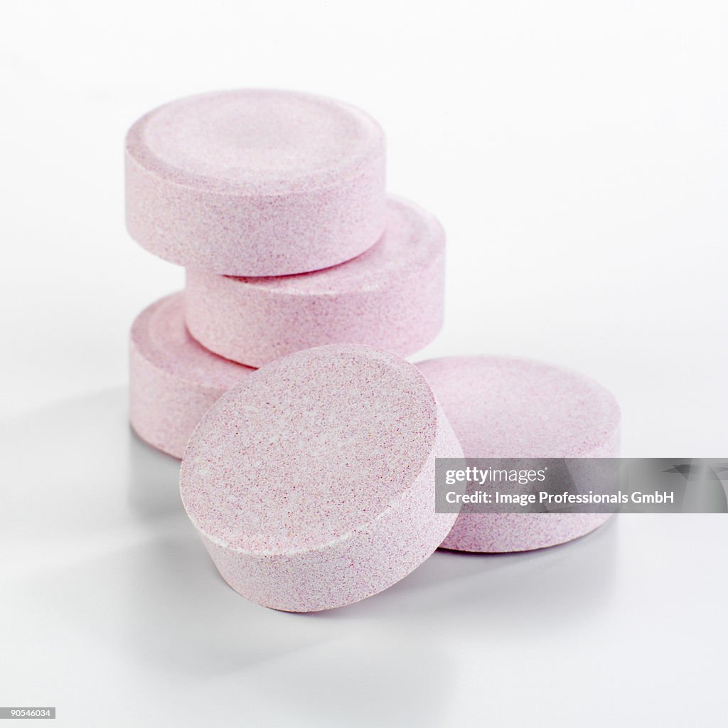 Magnesium tablets on white background, close up