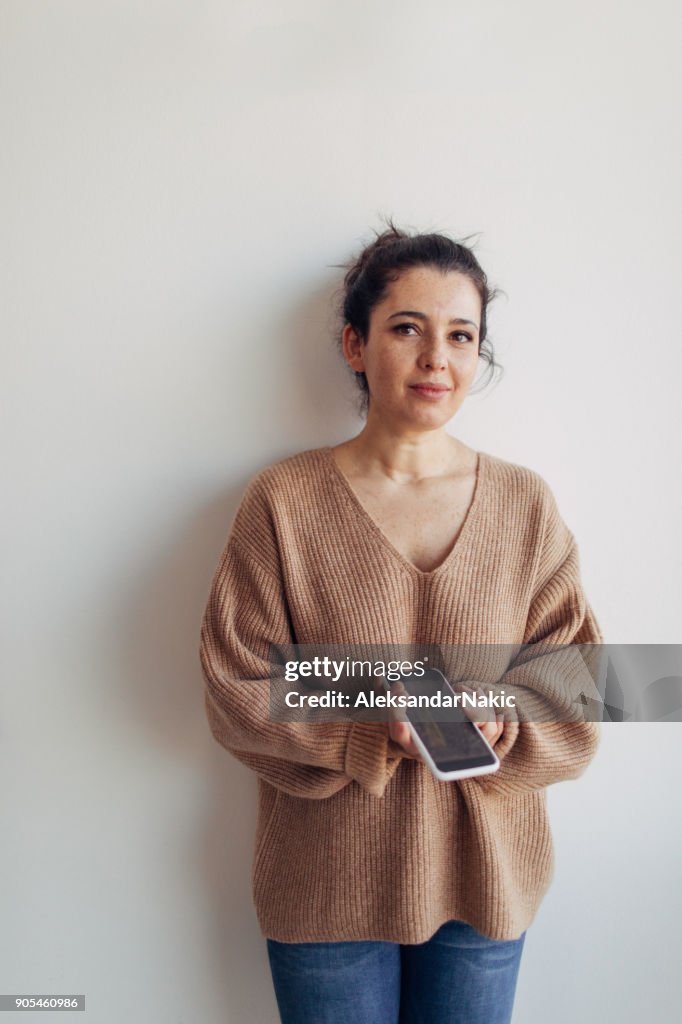 Portrait of a woman holding mobile phone