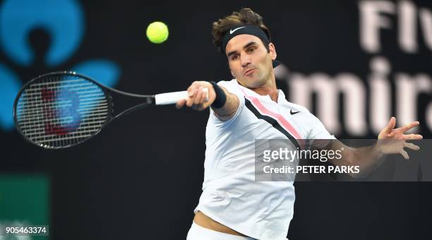 Switzerland's Roger Federer hits a return against Australia's Alex De Minaur during their men's singles first round match on day two of the...