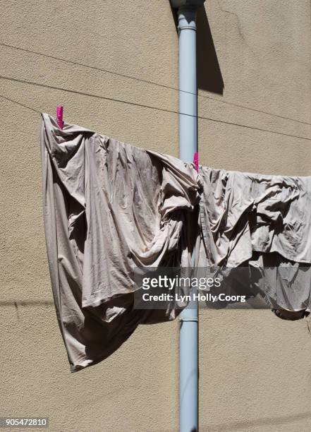sheet drying in the sun in inner-city lisbon - lyn holly coorg stock pictures, royalty-free photos & images