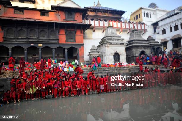 Nepalese Hindu Devotees lining to take holy water from Bagmati River at Pashupathnath Temple, Kathmandu during Madhav Narayan Festival or Swasthani...