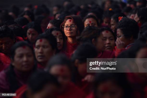 Nepalese Hindu woman offering ritual prayer at Pashupathnath Temple, Kathmandu during Madhav Narayan Festival or Swasthani Brata Katha on Tuesday,...