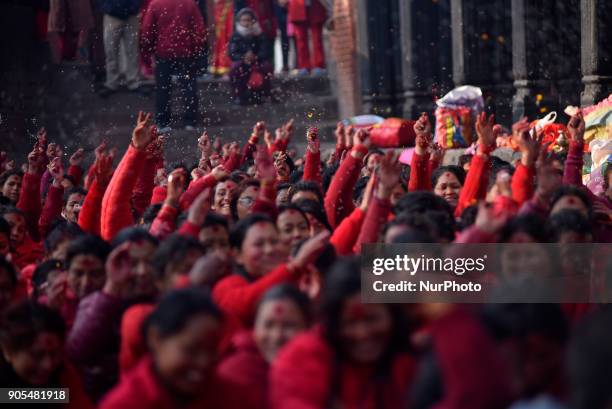 Nepalese Hindu woman offering ritual prayer at Pashupathnath Temple, Kathmandu during Madhav Narayan Festival or Swasthani Brata Katha on Tuesday,...