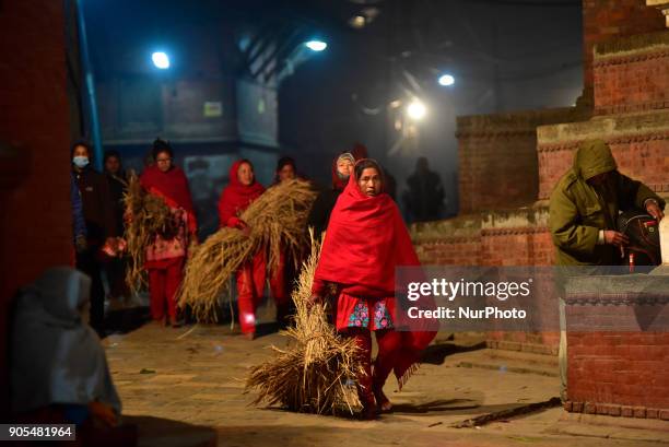 Nepalese Hindu woman arives for the ritual procession at Pashupathnath Temple, Kathmandu during Madhav Narayan Festival or Swasthani Brata Katha on...