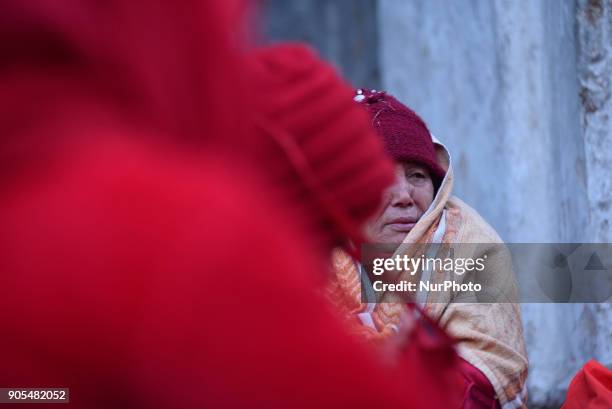 Nepalese Hindu woman offering ritual prayer at Pashupathnath Temple, Kathmandu during Madhav Narayan Festival or Swasthani Brata Katha on Tuesday,...