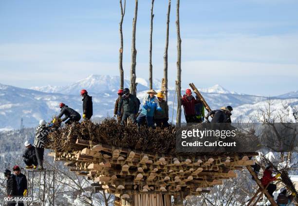 Men work on constructing the shrine during preparations for the Nozawaonsen Dosojin Fire Festival on January 15, 2018 in Nozawaonsen, Japan. The...