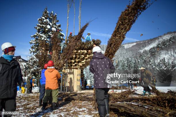 Men work on constructing the shrine during preparations for the Nozawaonsen Dosojin Fire Festival on January 15, 2018 in Nozawaonsen, Japan. The...