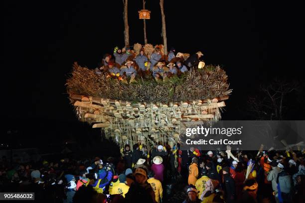 Village men sit atop the shrine during the Nozawaonsen Dosojin Fire Festival on January 15, 2018 in Nozawaonsen, Japan. The festival is staged by...