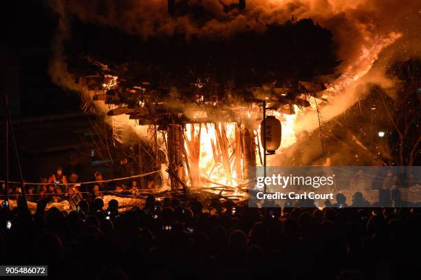 The shrine burns during the Nozawaonsen Dosojin Fire Festival on January 15, 2018 in Nozawaonsen, Japan. The festival is staged by village men of...