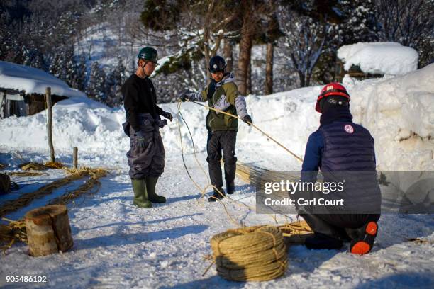 Village men prepare rope that will be used in the construction of the shrine during preparations for the Nozawaonsen Dosojin Fire Festival, on...