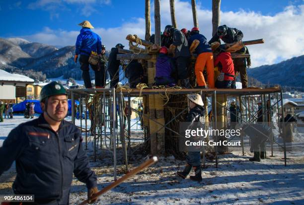 Village men work on building a shrine during preparations for the Nozawaonsen Dosojin Fire Festival, on January 14, 2018 in Nozawaonsen, Japan. The...