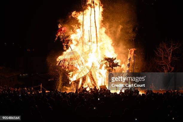 The shrine and a family totem pole are burned during the Nozawaonsen Dosojin Fire Festival on January 15, 2018 in Nozawaonsen, Japan. The festival is...