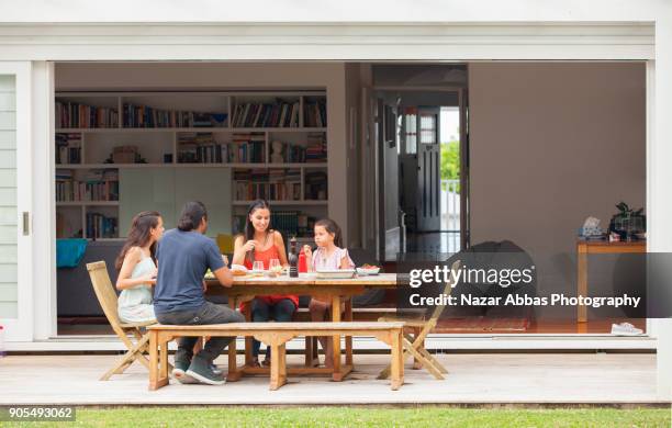 enjoying a meal at home. - ピクニックテーブル ストックフォトと画像