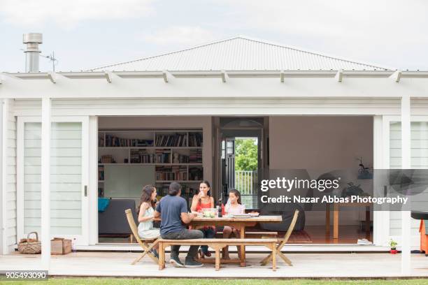 pacific island family enjoying meal at home. - new zealand housing stock pictures, royalty-free photos & images