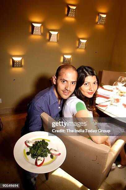 Andrea Pauro with his wife Pia, owner of Baci Restaurant at his Restaurant in Sunder Nagar market, New Delhi, India