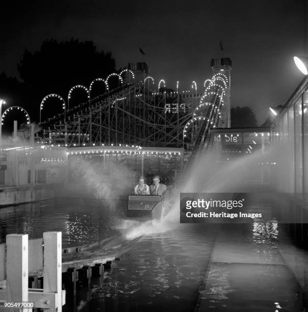Festival Pleasure Gardens, Battersea Park, Wandsworth, London, 1955-1960. Passengers riding the waterchute fairground ride at the Battersea Festival...