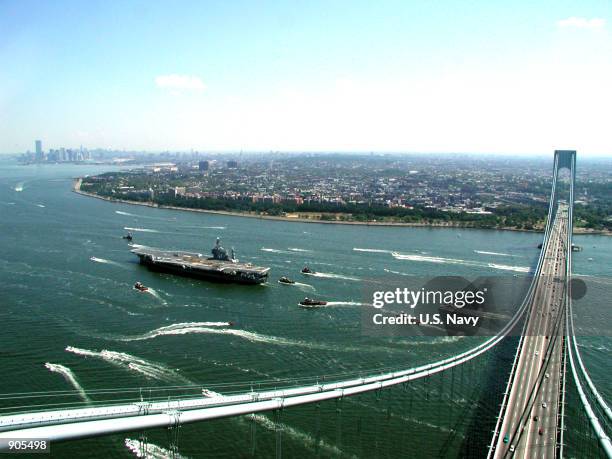 The aircraft carrier USS John F. Kennedy passes under the Verrazano Narrows Suspension Bridge July 2, 2000 between Staten Island and Brooklyn, New...