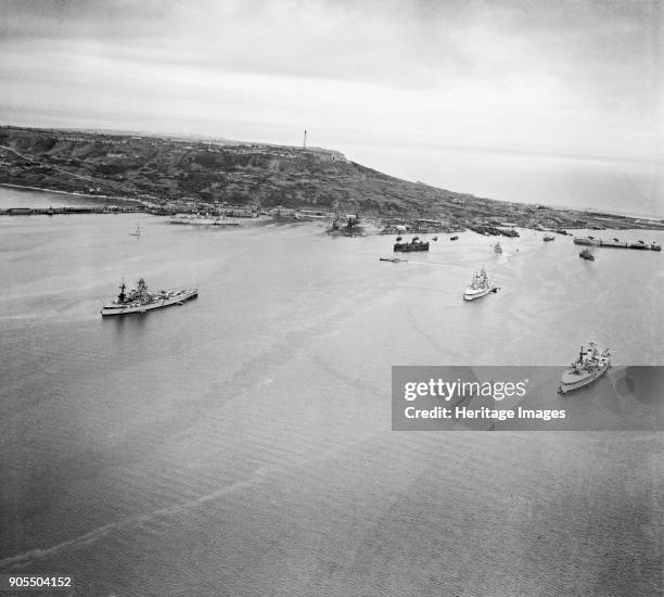 Portland Harbour, Dorset, 1946. The port and harbour from the north. HMS 'Nelson' and two other battleships at anchor. Also visible are a string of...