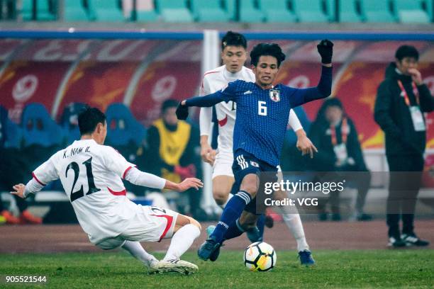 Yoichi Naganuma of Japan and Kim Nam-Il of North Korea compete for the ball during the AFC U-23 Championship Group B match between Japan and North...