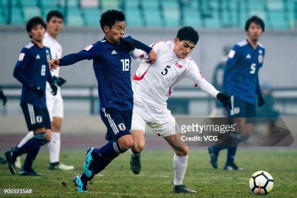 Hatate Reo of Japan and Ri Un-Chol of North Korea compete for the ball during the AFC U-23 Championship Group B match between Japan and North Korea...