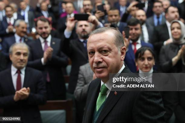 Turkish President Recep Tayyip Erdogan greets people during the Justice and Development Party group meeting at the Grand National Assembly of Turkey...