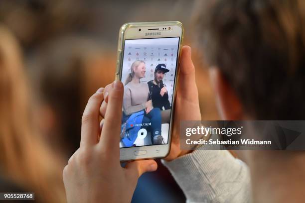 Child is filming Felix Neureuther and his wife Miriam Neureuther on his smart phone during the 2018 PyeongChang Olympic Games German Team kit...