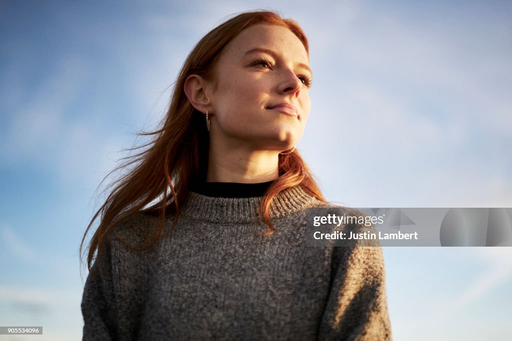 Young lady looking content in the winter sunshine