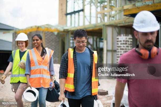 group of builders on construction site leave for home - afterwork stock pictures, royalty-free photos & images