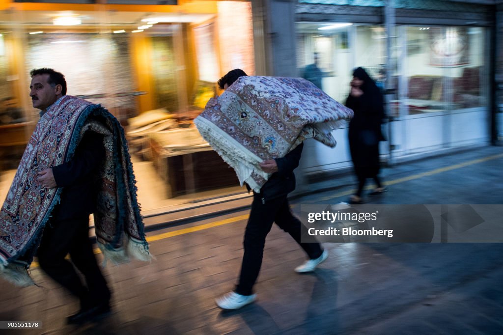Syrian Rug Salesman Two man carry Persian carpets on their shoulders through the rug ...