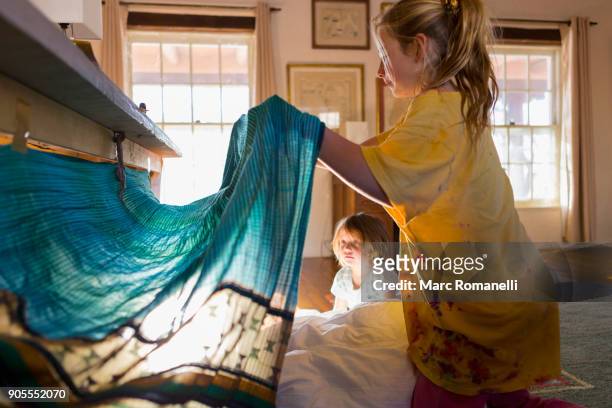 caucasian brother and sister playing with fort under table - kids fort stock pictures, royalty-free photos & images