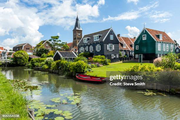 rowboat in canal at traditional village - marken stockfoto's en -beelden