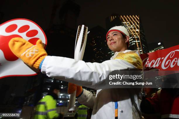 South Korean actor Park Bo-Gum holds the PyeongChang 2018 Winter Olympics torch during the PyeongChang 2018 Winter Olympic Games torch relay on...