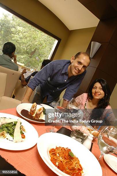 Andrea Pauro with his wife Pia, owner of Baci Restaurant at his Restaurant in Sunder Nagar market, New Delhi, India